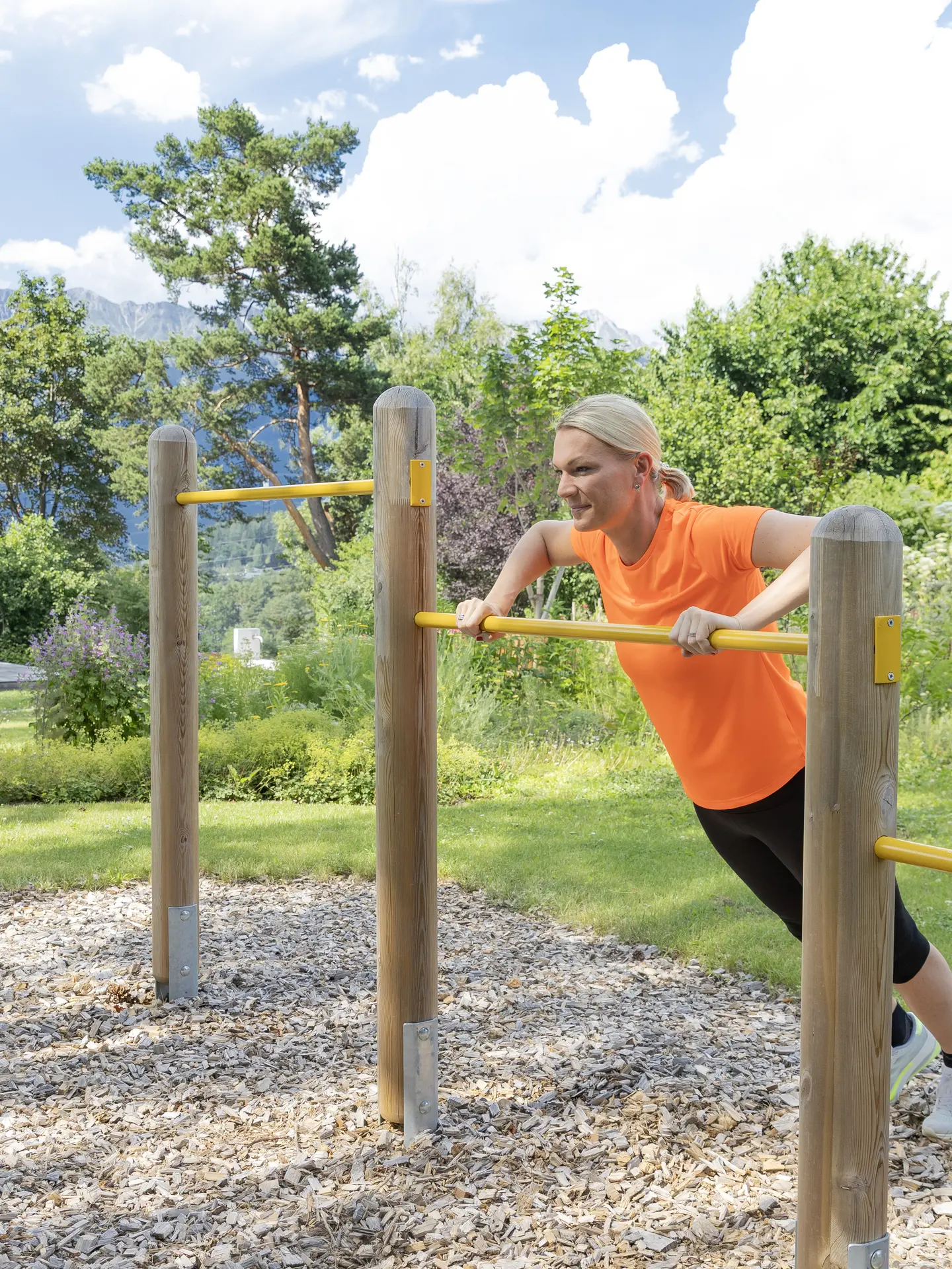 Maria Höfl-Riesch training on the horizontal bar in the garden at Park Igls