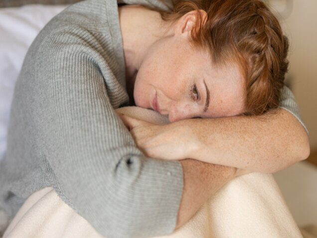 Thoughtful middle-aged woman with long red hair – a moment of self-reflection at Park Igls Medical Spa Resort