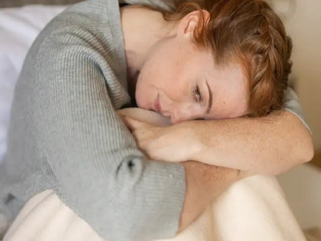 Thoughtful middle-aged woman with long red hair – a moment of self-reflection at Park Igls Medical Spa Resort