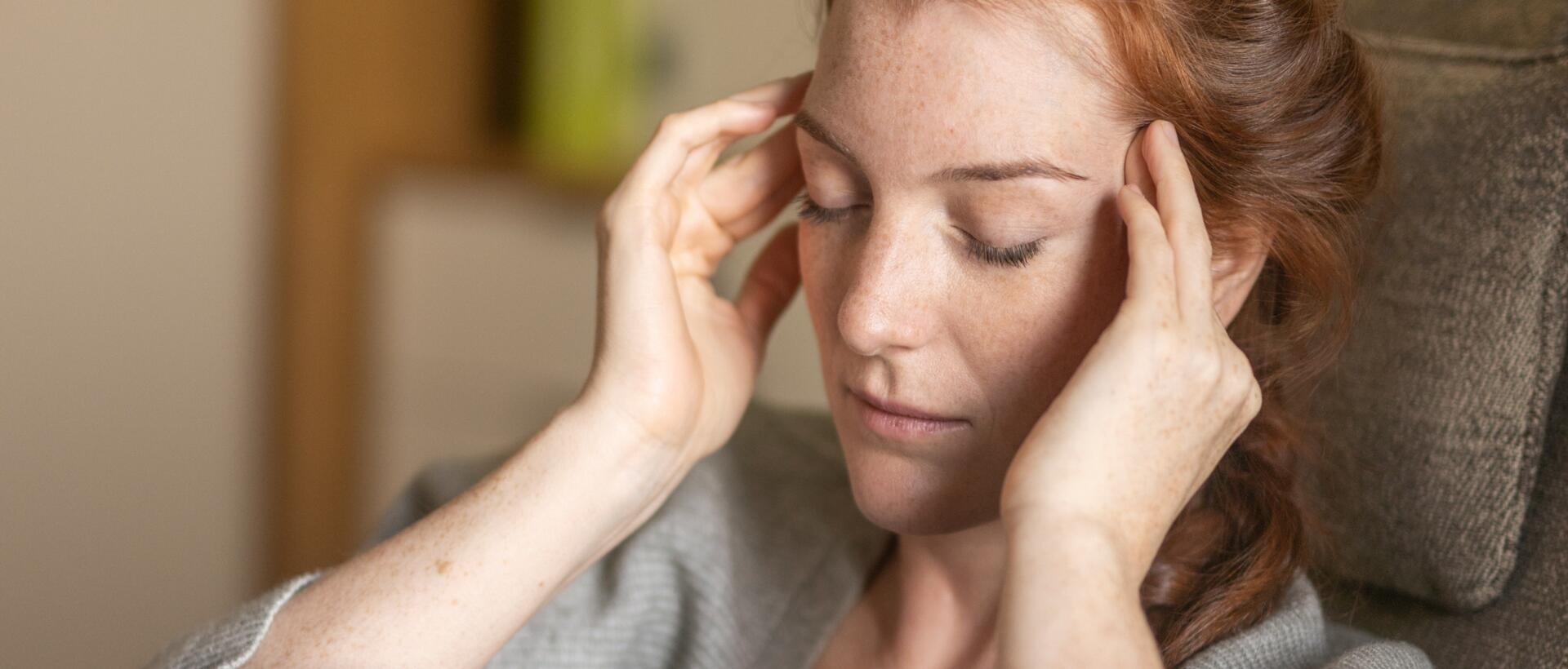 Thoughtful middle-aged woman with long red hair – a moment of self-reflection at Park Igls Medical Spa Resort
