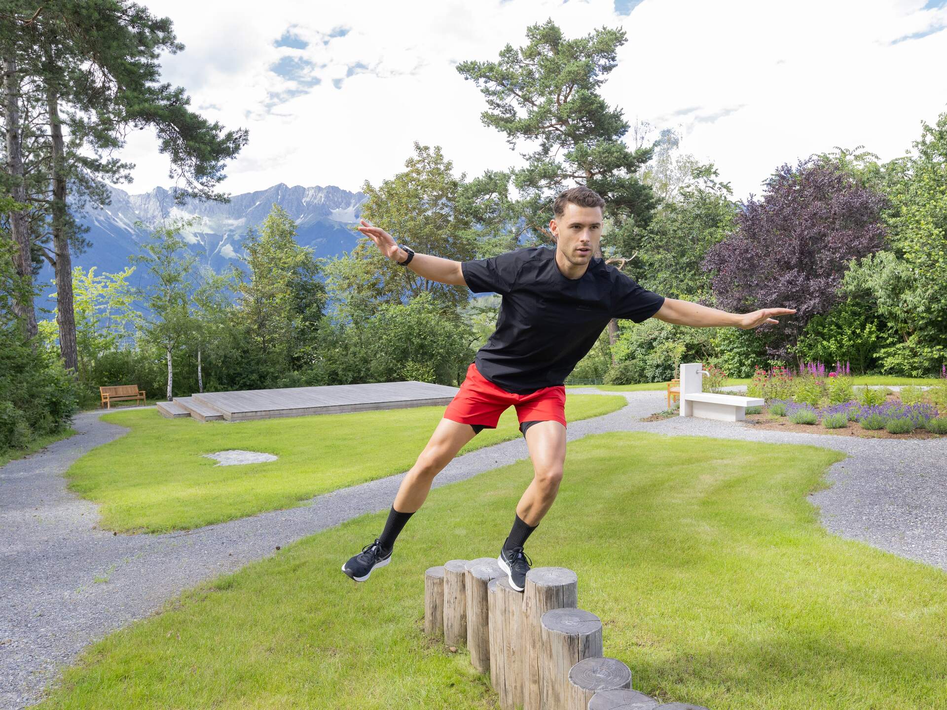 Man balancing on wooden pegs in the park