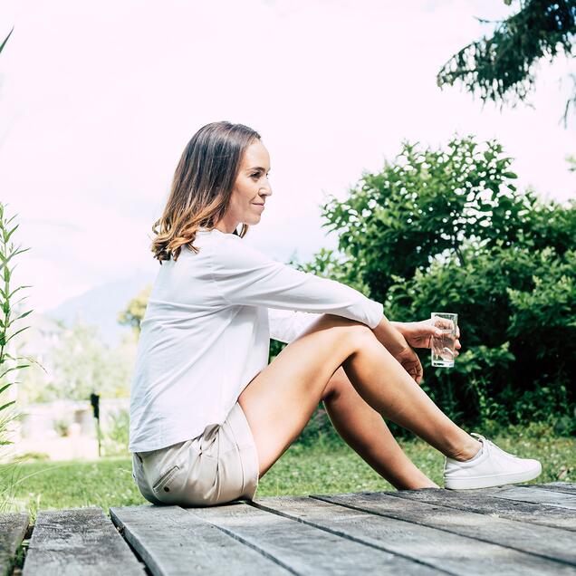 Woman sits in the grass and enjoys 
