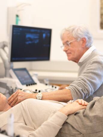 Woman lying down during carotid artery ultrasound examination