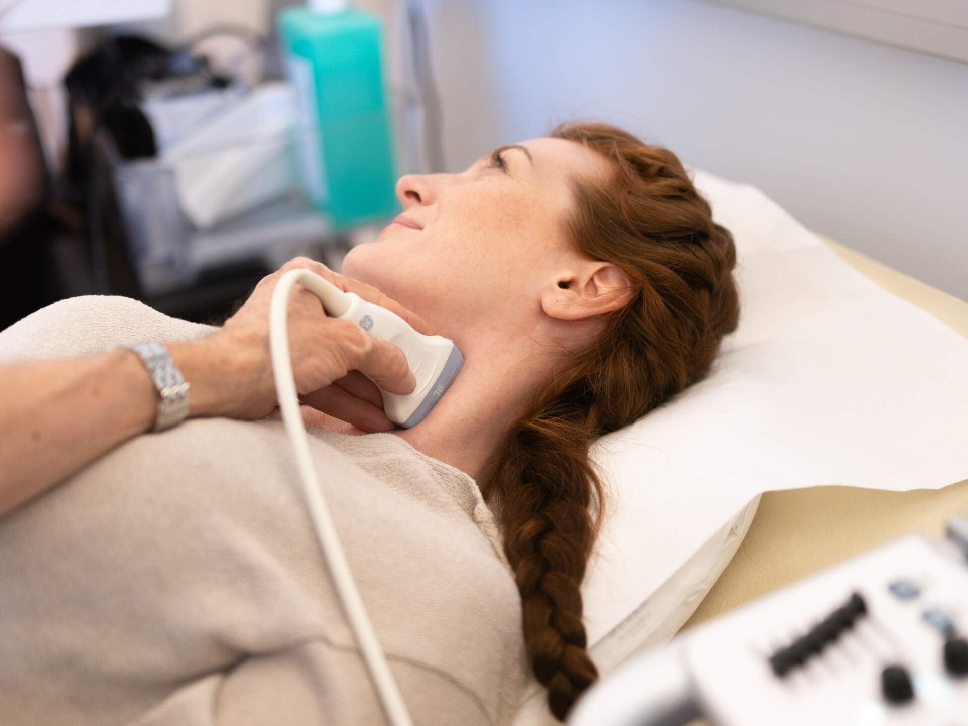 Woman lying down during carotid artery ultrasound examination