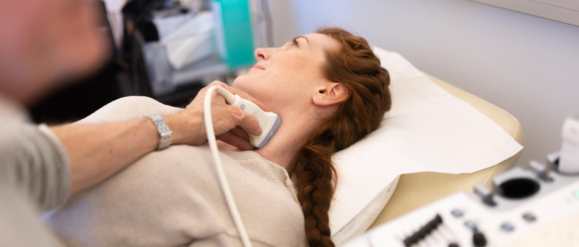 Woman lying down during carotid artery ultrasound examination